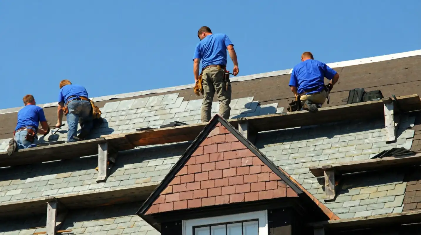 Roof replacement in progress with a team of professional contractors installing new shingles on a residential home in Tulsa, OK