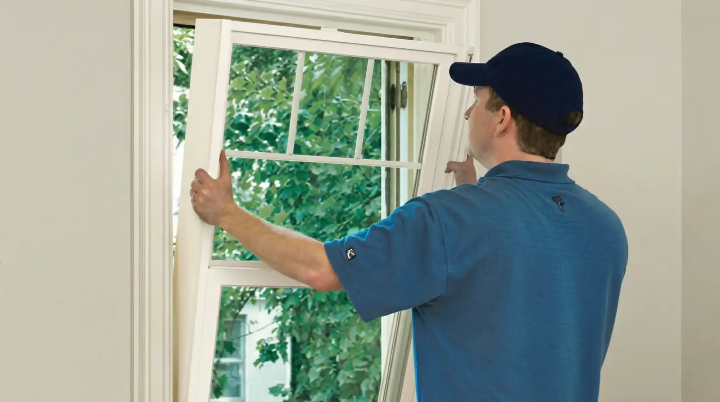 Professional contractors performing a residential window insulation and replacement service in Tulsa, OK